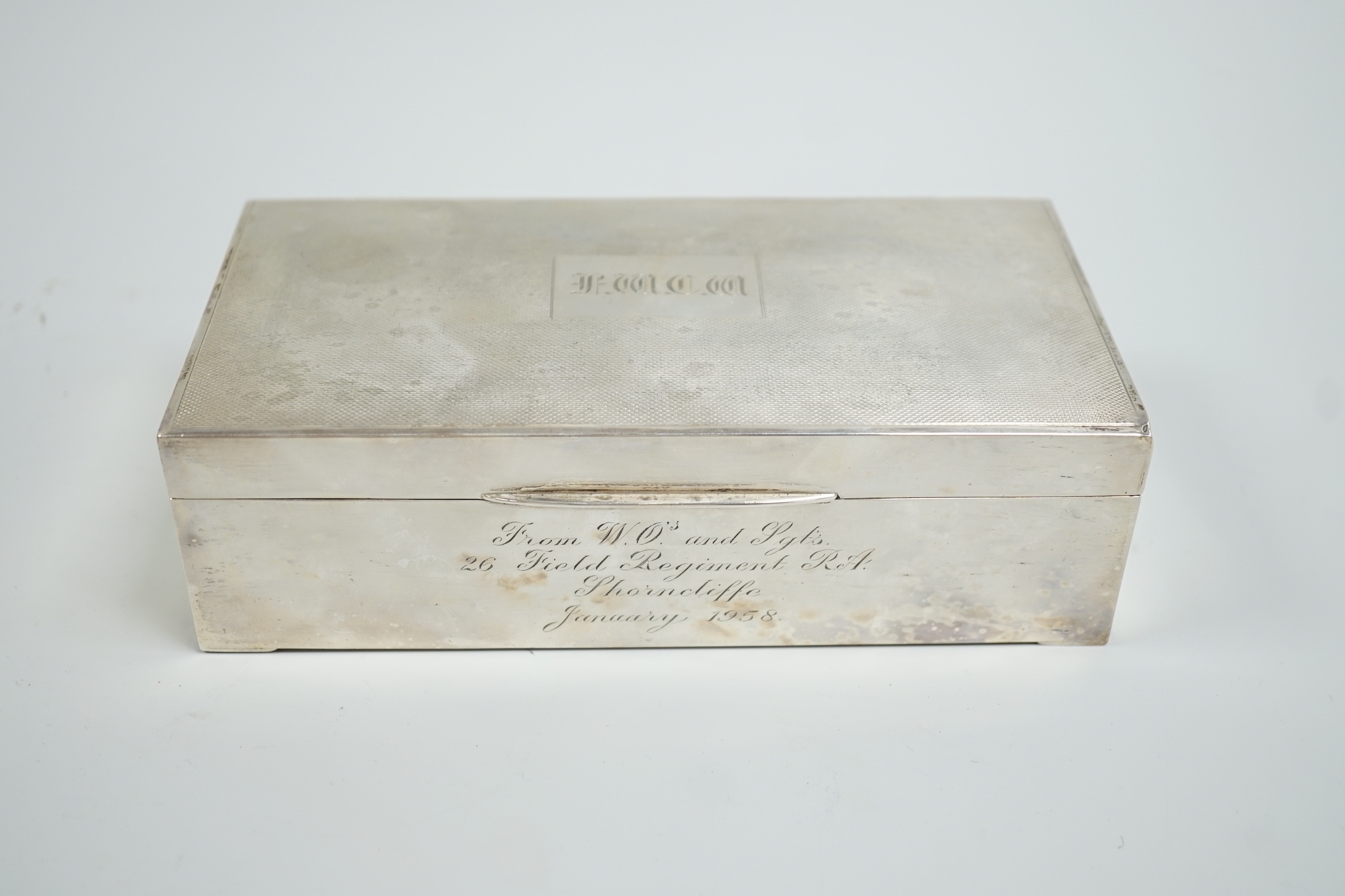 A Elizabeth II engine turned silver mounted rectangular cigarette box, 17.8cm, with engraved inscription, Birmingham, 1952.